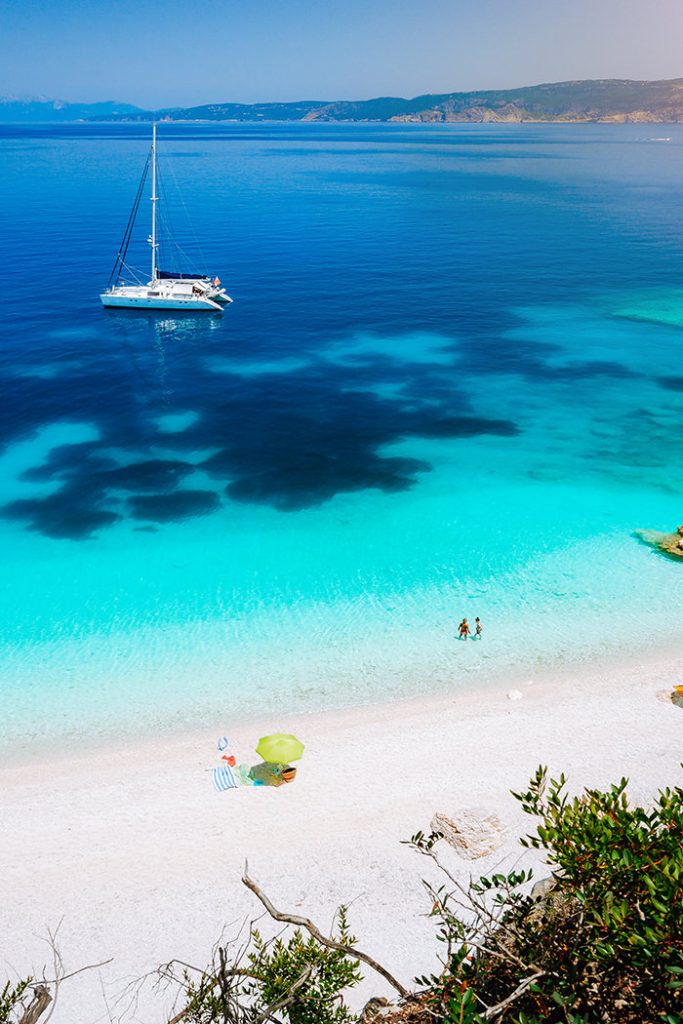 Catamaran boat anchored across the beach